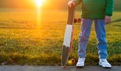 guy with a skateboard at sunset