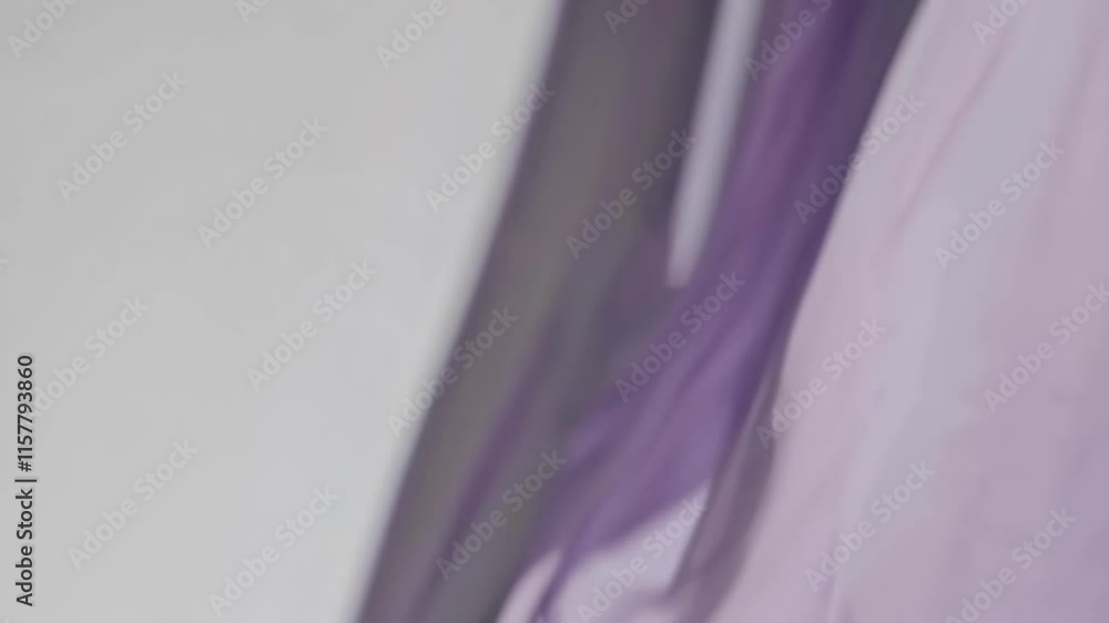 Poster flowing lavender fabric with smooth drapes, creating a soft and airy appearance.