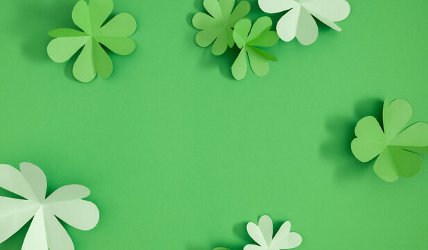 Patrick's Day composition. Four-leaf clover paper art. St Patrick's Day four leaf clover on green background. Flat lay