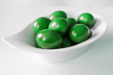 Traditional green easter eggs. Chicken eggs are painted red. High quality photo