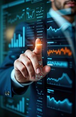 Businessman interacts with large interactive display screen showing virtual data graphs, charts. Uses fingertip gesture on screen with lots of financial data. Futuristic business tech displayed on