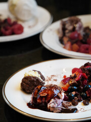 A delicious Christmas dessert of berries and ice cream with chocolate sauce