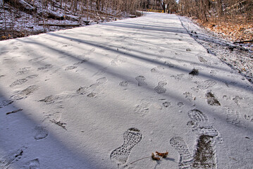 Footprint on the footpath after the snowfall in winter