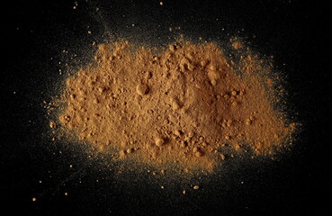 Red maca organic powder scattered isolated on black, top view