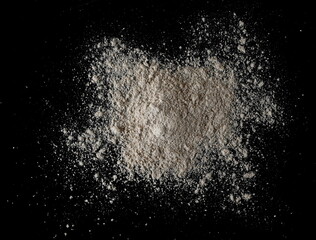 Integral spelt flour pile, isolated on black, top view