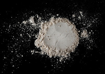 Integral spelt flour pile, isolated on black, top view