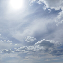 Sun on beautiful blue sky with white clouds.