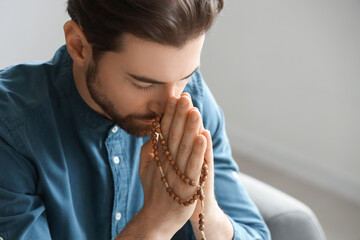 Bearded man praying at home
