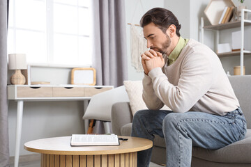 Religious man reading Bible at  home