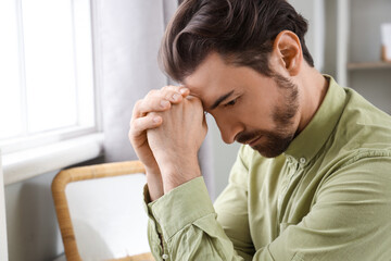 Religious man praying at  home