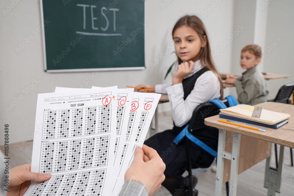 Poster teacher with checked answer sheets in classroom, closeup