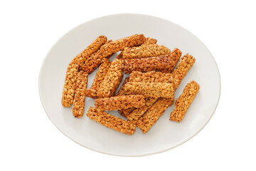 Gozinaki in a plate isolated on white background. Homemade seed sunflower candies. Sweet granola in plate for holiday.