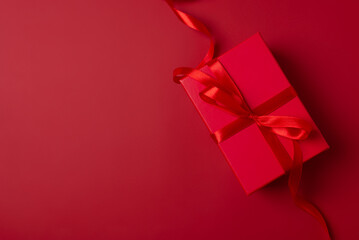 Xmas gift box and decoration celebration in Christmas theme. Red present box on red background....