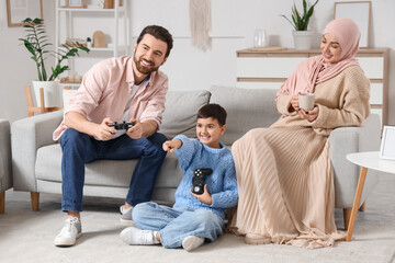 Happy Muslim family playing video game at home
