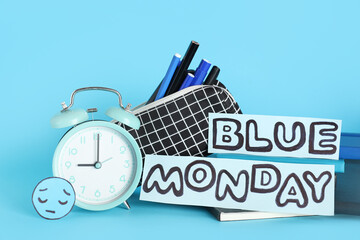 Text BLUE MONDAY, office stationery with sad face and alarm clock