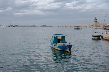 Old rusty fishing boat in Monopoli port quiet Mediterranean waters South Italy