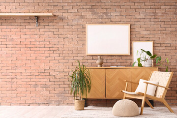 Interior of living room with armchair, commode and blank frame