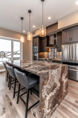 Modern Kitchen with Large Stone Countertop, Stainless Steel Appliances, and Ample Natural Light