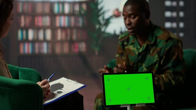 Military soldier experiences shell shock at counseling next to copy space, dealing with trauma recovery and share his feelings. Army trooper with PTSD and combat flashbacks scenes. Camera B.