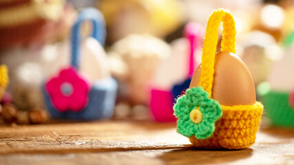 Brightly colored miniature crocheted baskets hold individual eggs, each basket adorned with a dainty flower detail, making them perfect for Easter celebrations.