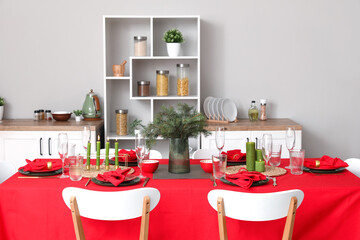 Stylish table setting for Christmas dinner in kitchen