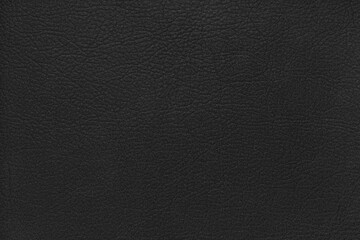 Fototapeta premium Natural, genuine solid black leather texture close up, macro. Structure of matte leatherette, artifical skin surface with embossing pattern. Background, wallpaper, backdrop