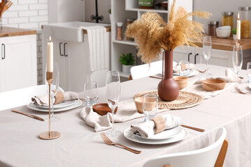 Stylish table setting for dinner in kitchen