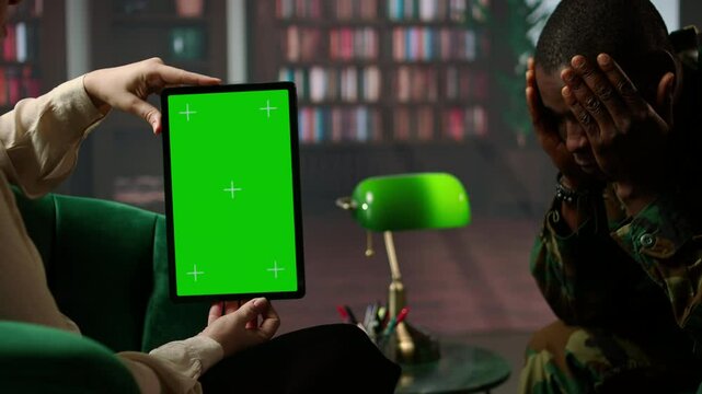 Psychotherapy session for a military veteran in distress with mockup screen, showcasing counseling support for PTSD and trauma after combat. Armed forces soldier with war flashbacks. Camera A.