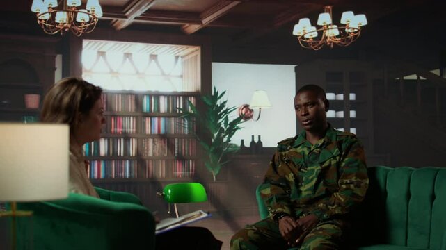 Portrait of army trooper meeting with a counselor to discuss about anxiety and distress due to PTSD and battle trauma, shell shock and mental disorder. Depressed trooper at counseling. Camera B.