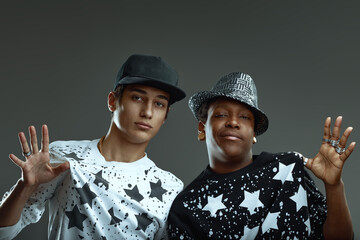 Two young rappers showing cool attitude and hand gestures