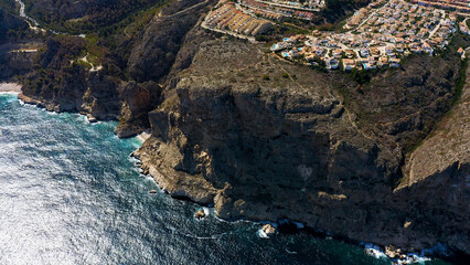Aerial view of the chalet developments in the Cumbres del Sol, located next to the beautiful cliffs of the town of Benitachell, in the Mediterranean province of Alicante, Spain.