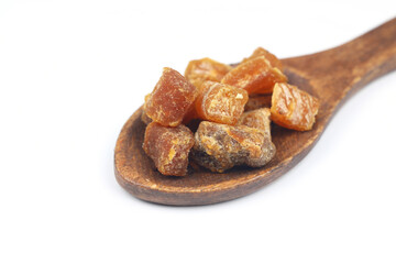 Mix of nuts and dried fruits in wooden spoon isolated on a white background.