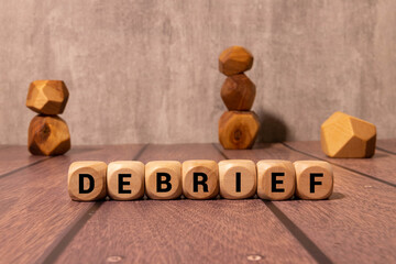Debrief symbol. Concept word Debrief on wooden blocks.