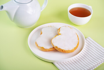 Lemon jam white glazed puffed cakes in a plate