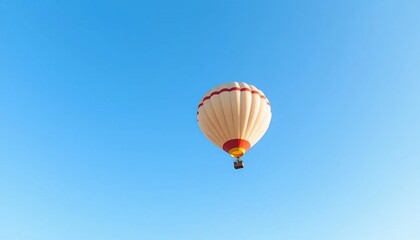 Naklejka premium Hot Air Balloon Soaring High in a Clear Blue Sky