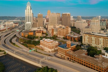 Aerial view of downtown Cincinnati at sunrise. Interstate highway system and city buildings are prominent. Downtown, Cincinnati, Ohio, United States