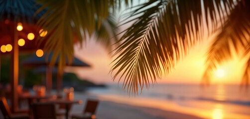 Sunset beach bar with warm colors. Palm trees frame a blurred beach scene. Warm lights create a cozy atmosphere. People relax at tables. A perfect evening.