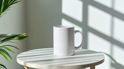 A white ceramic mug with no design placed on a table with soft shadows