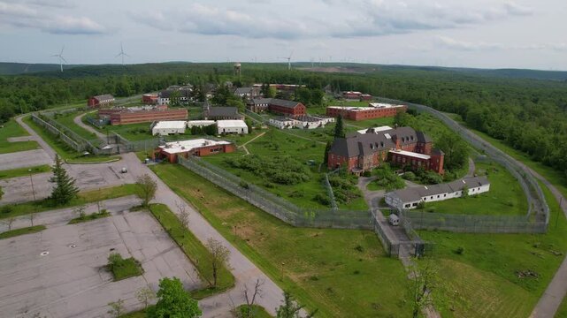 PENNSYLVANIA - 7.11.2024 - Excellent aerial footage approaching and moving over an abandoned sanitarium and prison in rural Pennsylvania.