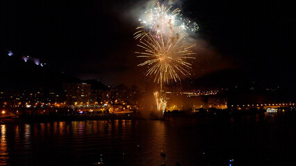 Fototapeta premium Nocturne aerial view of the fireworks launched in the beach of El Postiguet, in the Mediterranean city of Alicante, Spain.