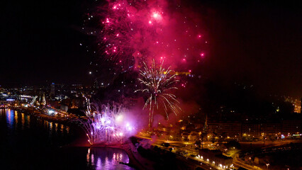 Obraz premium Nocturne aerial view of the fireworks launched in the beach of El Postiguet, in the Mediterranean city of Alicante, Spain.