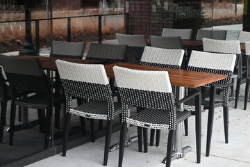 tables and chairs outside of a cafe
