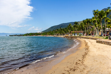 ILHABELA, SP, BRAZIL - DECEMBER 06, 2024: Pereque Beach with a cruise ship in the background and Baepi peak on the right.