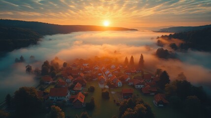 aerial drone bird s eye view photo of european village of central europe with red roofs and cozy streets beautiful natural morning sun lights and a fog in the valley