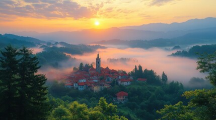 from above of old town on slope of hill among green forest covered with thick fog under colorful morning sky
