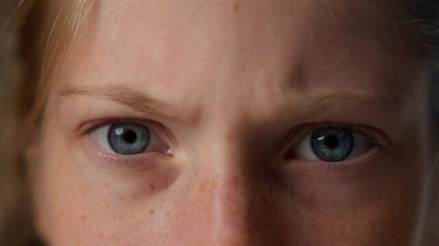 Close up unhappy face eyes look sight children little girl angry mad Caucasian furious child kid naughty student schoolgirl irritated pupil looking camera frowning expression negative frustrated anger