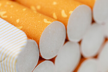 A stack of cigarettes with a yellow wrapper