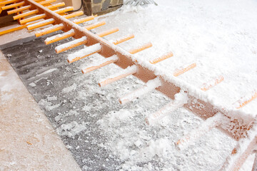 Snow-covered metal staircase with grated steps in winter