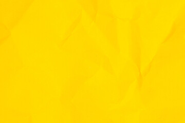 A yellow piece of paper with a crumpled texture