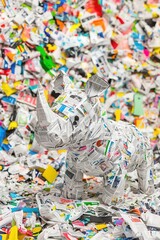 Fototapeta premium Paper Sculpture of Rhinoceros Surrounded by Colorful Trash